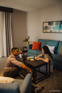 young couple play board games in a Rewind Hotel suite
