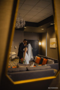 newly wed couple kissing in pre-function space at the Rewind Hotel