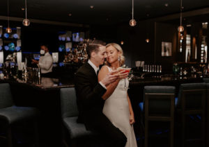 Wedding couple having a drink at the Johnny's Italian Steakhouse bar