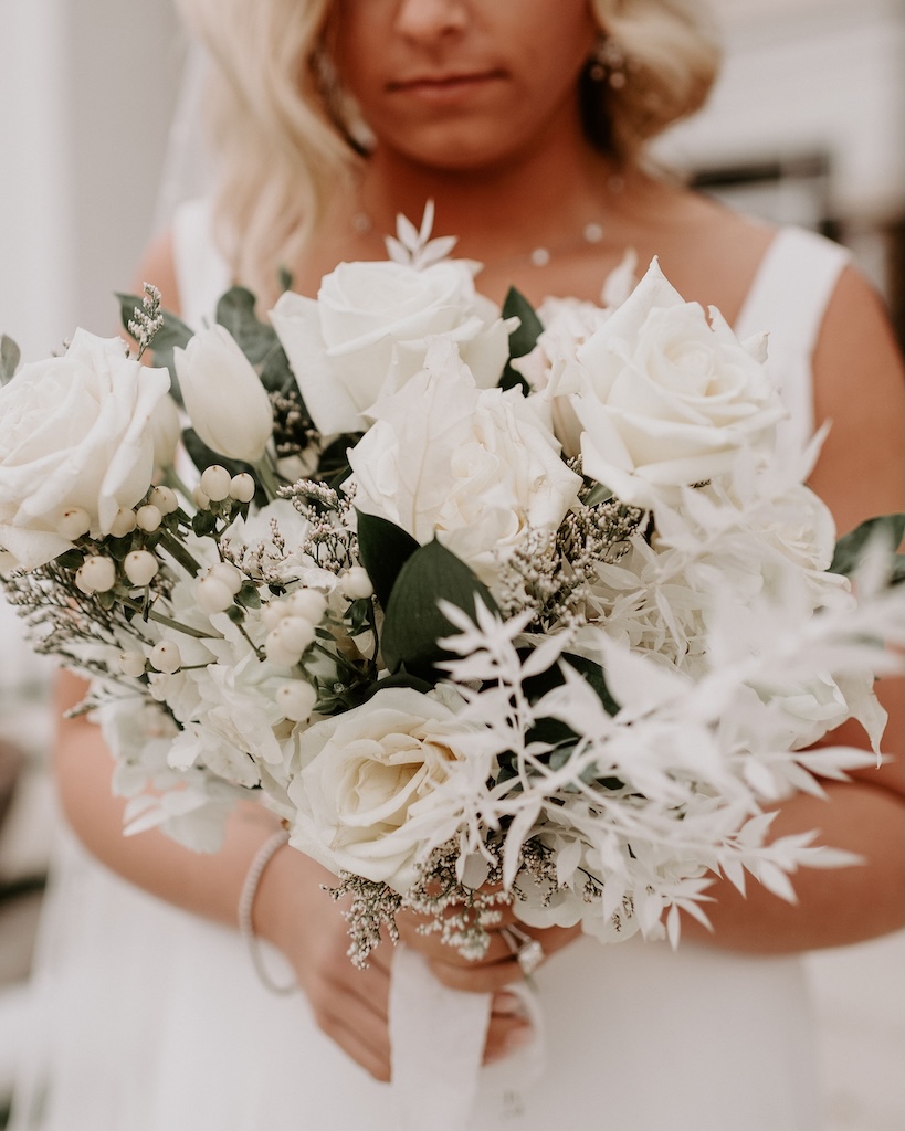 wedding bride holding white flower bouquet